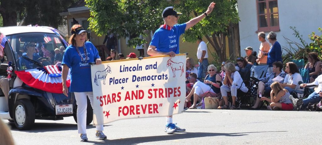 A man holding a sign that says " stars and stripes forever ".